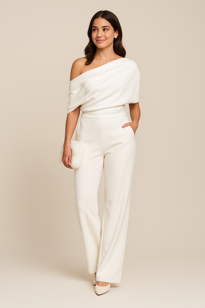 Woman wearing a white off-shoulder top and pants against a beige background